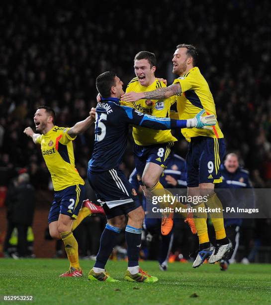 Sunderland's Vito Mannone celebrates with Craig Gardner and Steven Fletcher, after Manchester United's Rafael Da Silva's missed penalty during the...