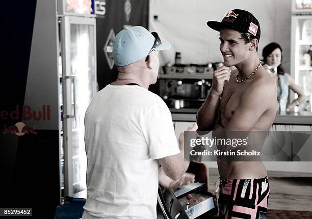 Quiksilver Pro wildcard surfer Julian Wilson of Australia chats to Quiksilver Team Manager Steven Bell in the competitors area after winning his...
