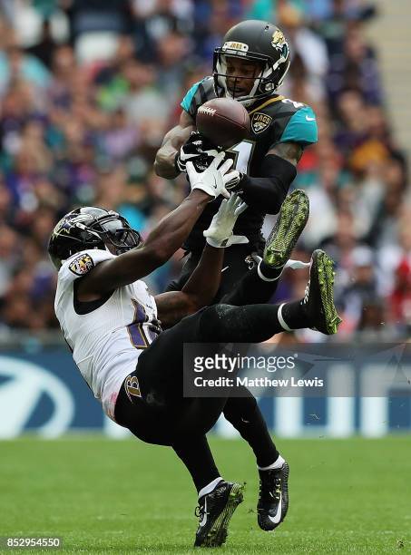 Bouye of the Jacksonville Jaguars intersects the ball from Jeremy Maclin of the Baltimore Ravens during the NFL International Series match between...