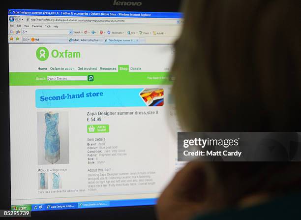 Oxfam volunteer Kelston Shiner checks a dress on their website that has been sold via their online store at the Oxfam online hub warehouse on March 6...