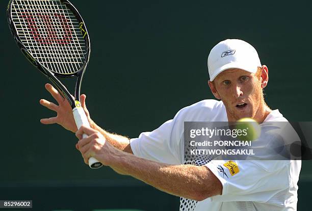 Australia tennis player Chris Guccione views the ball as he returns to Kittipong Wachiramanowong of Thailand during the Davis Cup Asia/Oceania Zone...
