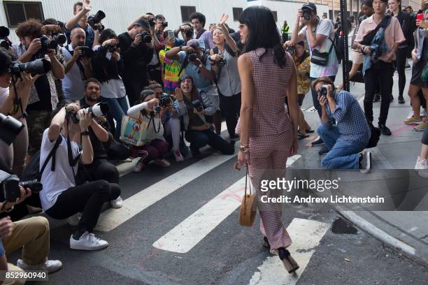 Outside of New York City's Fashion Week shows, models, photographers, attendees, and people simply wanting to be seen and photographed gather at the...