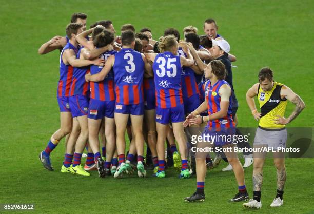 Ben Lennon of Richmond reacts after missing a kick after the siren as Port Melbourne players celebrate winning during the VFL Grand Final match...