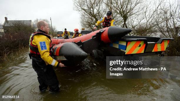 Members of the Avon and Somerset Police Underwater Search Unit prepare a RIB near to the village of Langport so that they can head to the village of...