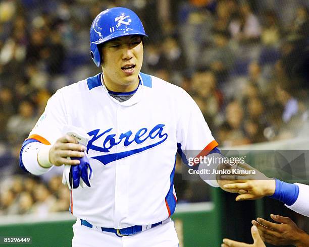 Outfielder Kim Hyun-Soo of South Korea celebrates after scoring in the bottom half of the fifth innings during the World Baseball Tokyo Round match...