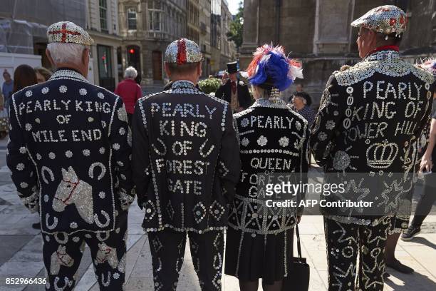 Pearly Kings and Queens attend a Harvest Festival service at the Guildhall in the City of London on September 24, 2017. Pearly kings and queens are a...