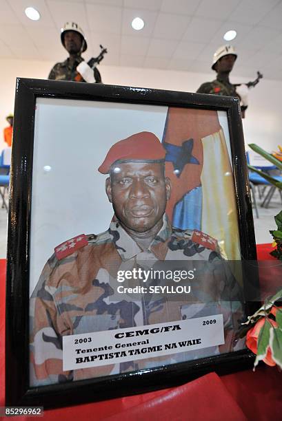 Soldiers stand on March 8, 2009 behind the portrait of Guinea-Bissau army chief, General Batista Tagme Na Waie, in Bissau during a state funeral a...