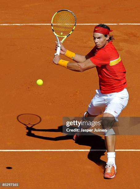 Rafael Nadal of Spain returns a forehand to Novak Djokovic of Serbia during day two of the Davis Cup World Group first round tie between Spain and...