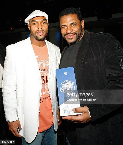 Chris Hope of the Tennessee Titans and NFL analyst and former Pittsburgh Steelers running back Jerome Bettis hold a Jose Cuervo Platino box at...