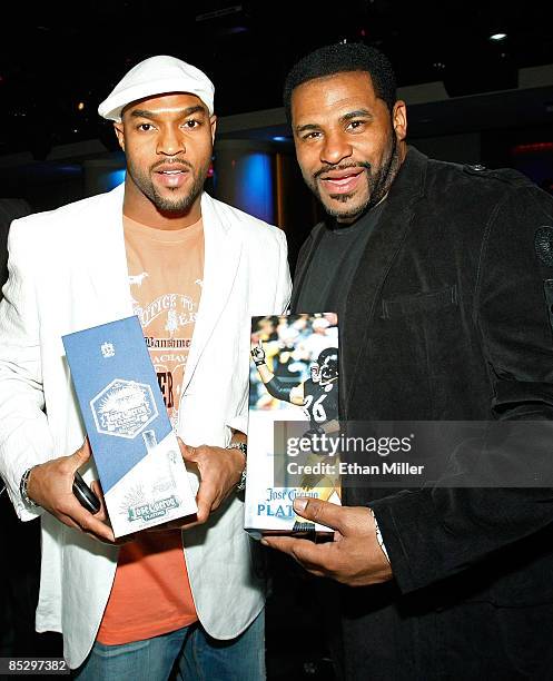 Chris Hope of the Tennessee Titans and NFL analyst and former Pittsburgh Steelers running back Jerome Bettis hold Jose Cuervo Platino boxes at...