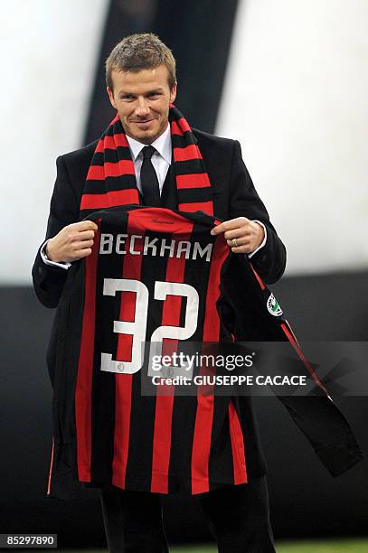 File photo taken December 21, 2008 shows British footballer David Beckham holding his AC Milan jersey prior to an Italian series A match at the San...