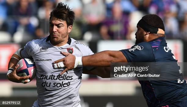 Stade Francais Paris' Australian prop Paul Alo-Emile tackles RC Toulon's Argentinian flanker Facundo Isa during the French Top 14 rugby union match...