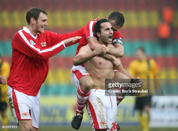 Kenan Sahin of 1. FC Union Berlin and his team mate Michael Bemben on his back and Christian Stuff celebrates the third goal during the Third...