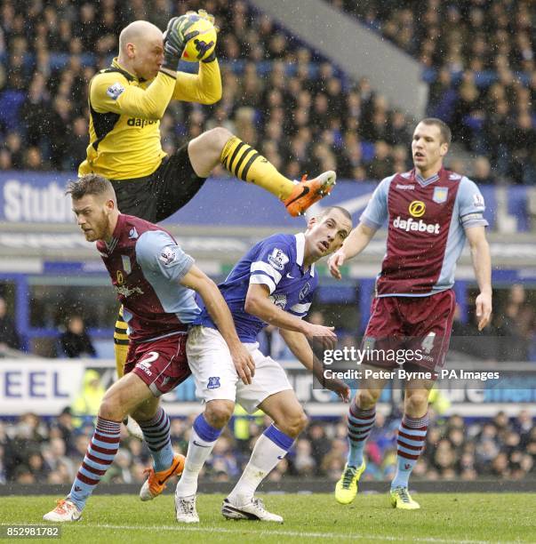 Aston Villa goalkeeper Bradley Guzan gathers the ball ahead of Everton's Leon Osman