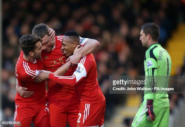 Southampton's Rickie Lambert is congratulated on scoring their second goal of the game with teammates Jay Rodriguez, left and Nathaniel Clyne, right...