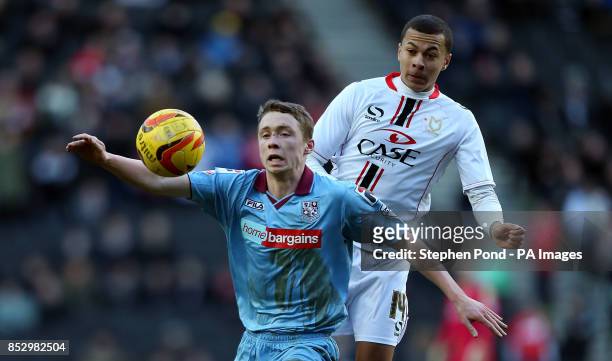 Dons' Dele Alli and Tranmere Rovers' Matthew Pennington compete for the ball during the Sky Bet League One match at Stadium:mk, Milton Keynes.