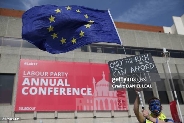 Protesters march along the seafront holding placards and waving European and Union flags in Brighton on September 24 on a march against Brexit. -...