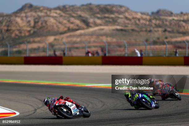 Jorge Lorenzo of Spain and the Ducati Team rides ahead of Valentino Rossi of Italy and Movistar Yamaha MotoGP, Andrea Dovizioso of Italy and the...