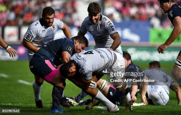 Stade Francais Paris' Tongan prop Siegfried Fisi'ihoi vies with RC Toulon's French-Algerian lock Swan Rebbadj during the French Top 14 rugby union...