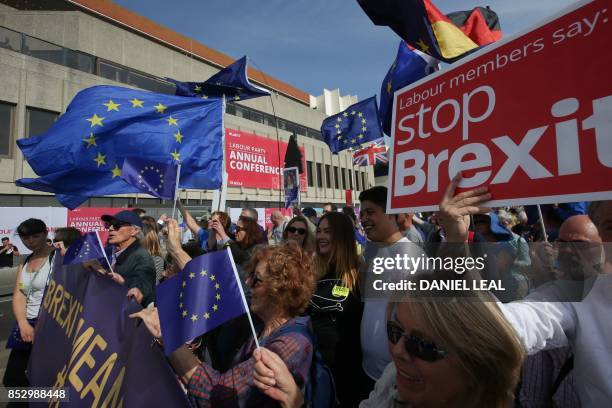 Protesters march along the seafront holding placards and waving European and Union flags in Brighton on September 24 on a march against Brexit. -...