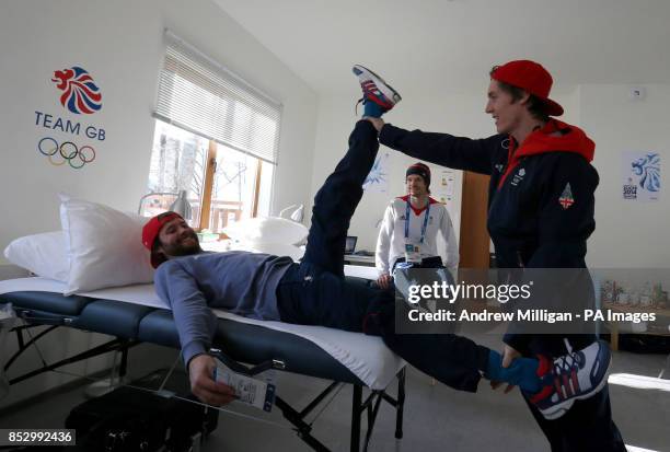 Great Britain's Billy Morgan has his leg stretched by Ben Kilner watched by Dom Harrington in the Athletes Village.