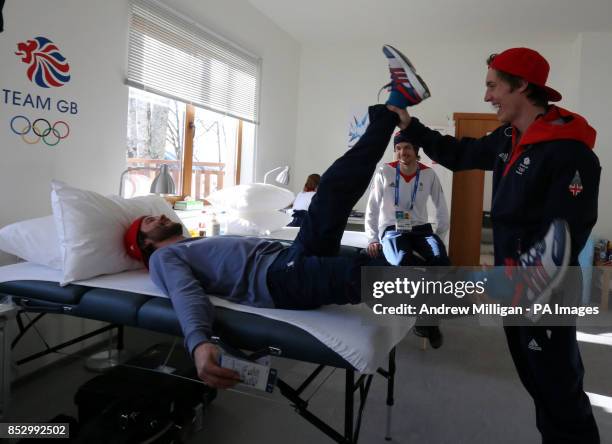 Great Britain's Billy Morgan has his leg stretched by Ben Kilner watched by Dom Harrington in the Athletes Village.