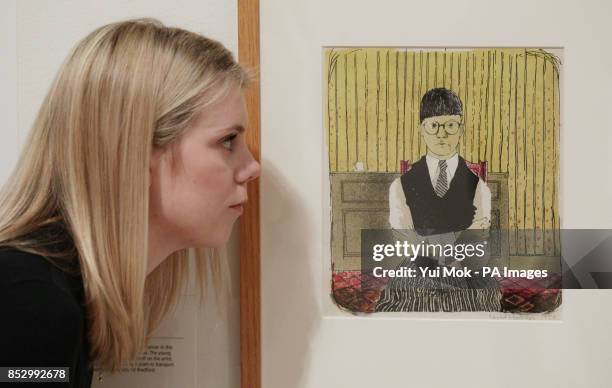 Gallery staff member Lucy Wood looking at David Hockney's 'Self Portrait' , during a press preview of the exhibition 'Hockney, Printmaker', at...