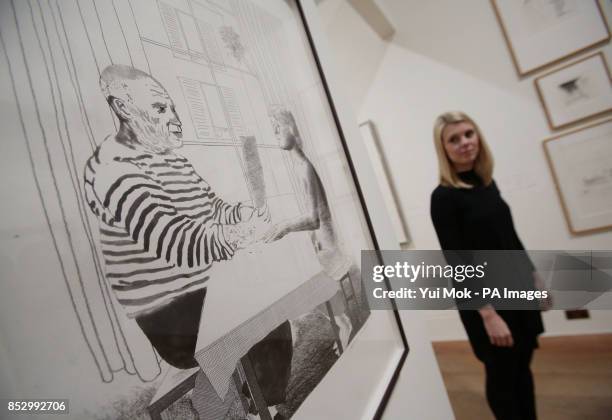 Gallery staff member Lucy Wood next to David Hockney's 'Artist and Model' , during a press preview of the exhibition 'Hockney, Printmaker', at...