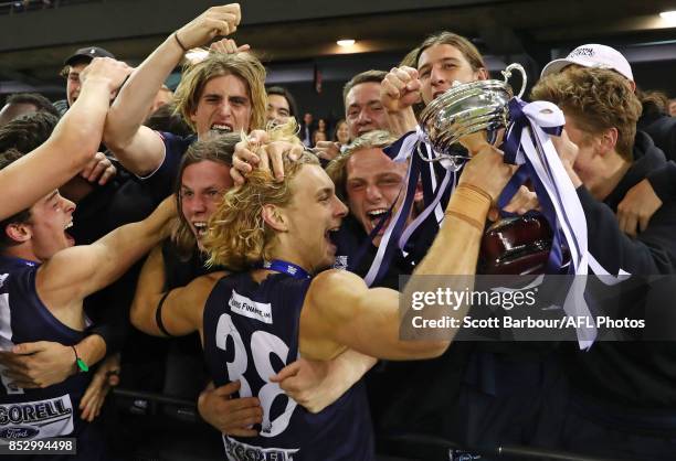 Geelong Falcons captain James Worpel celebrates with the trophy and fans in the crowd after winning the TAC Cup Grand Final match between Geelong and...