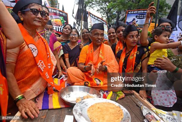 Shiv Sena activists protest against BJP government for the rising prices of petrol and diesel at Kurla, on September 23, 2017 in Mumbai, India. The...