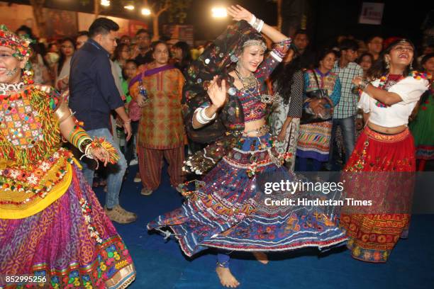 Women perform dandiya dance at "Thane Raas Rang Navratri Festival" at Modella Mill Compound, Thane, on September 23, 2017 in Mumbai, India. Dandiya...