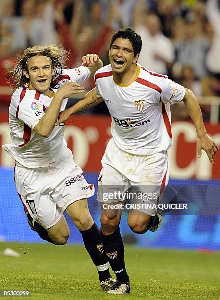 Sevilla's Renato Dirnei celebrates after scoring with Diego Capel against Almeria during their Spanish league football match against Almeria at...