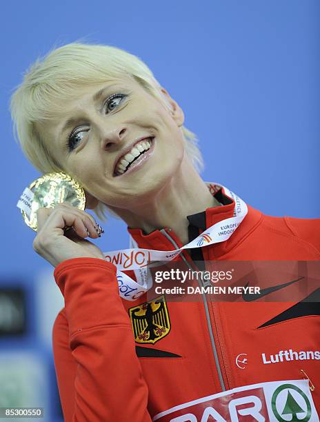 Gold medalist Germany�s Ariane Friedrich celebrates on the podium of the Women's High Jump of the European Athletics Indoor Championships on March 8,...