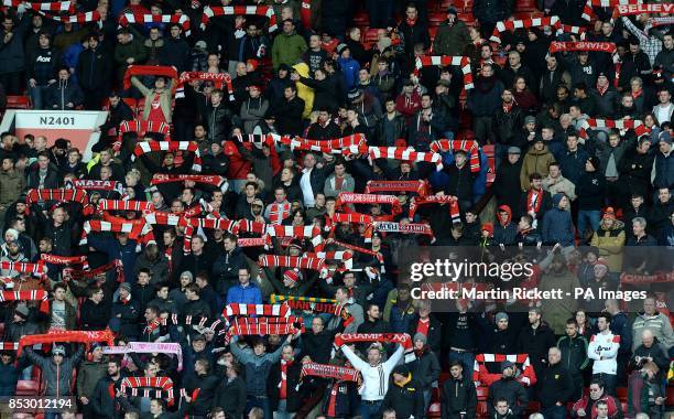 Manchester United fans hold their scarves up in memory of those who died in the Munich Air Disaster