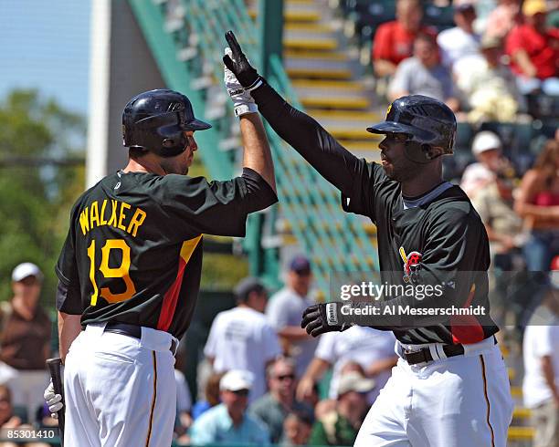 Outfielder Craig Monroe of the Pittsburgh Pirates celebrates a home run with infielder Neil Walker against the Houston Astros March 8, 2009 at...