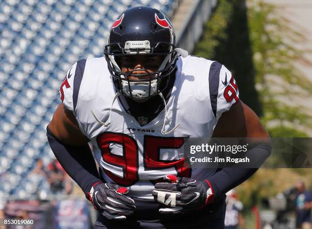 Christian Covington of the Houston Texans warms up before a game against the New England Patriots at Gillette Stadium on September 24, 2017 in...