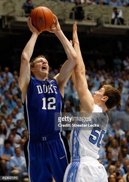 Kyle Singler of the Duke Blue Devils shoots the ball over Tyler Hansbrough of the North Carolina Tar Heels during their game at the Dean E. Smith...