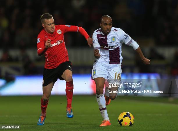 Aston Villa's Fabian Delph holds off a challenge from Cardiff City's Craig Noone during the Barclays Premier League match at the Cardiff City...