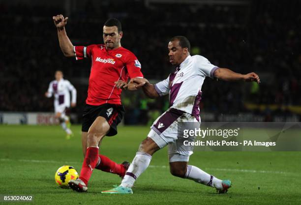 Aston Villa's Gabriel Agbonlahor is challenged by Cardiff City's Steven Caulker during the Barclays Premier League match at the Cardiff City Stadium,...