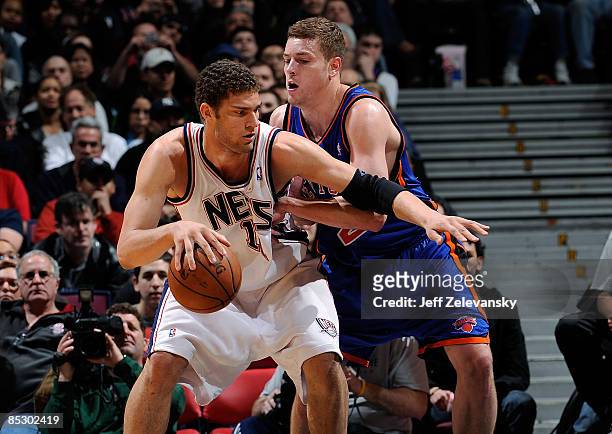 David Lee of the New York Knicks guards Brook Lopez of the New Jersey Nets on March 8, 2009 at the Izod Center in East Rutherford, New Jersey. NOTE...
