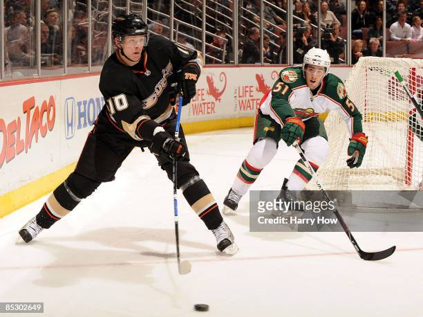 Corey Perry of the Anaheim Ducks makes a pass in front of James Sheppard of the Minnesota Wild during the first period at the Honda Center on March...