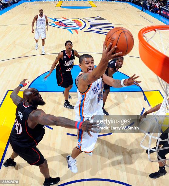Earl Watson of the Oklahoma City Thunder goes to the basket against Reggie Evans of the Philadelphia 76ers at the Ford Center on March 8, 2009 in...