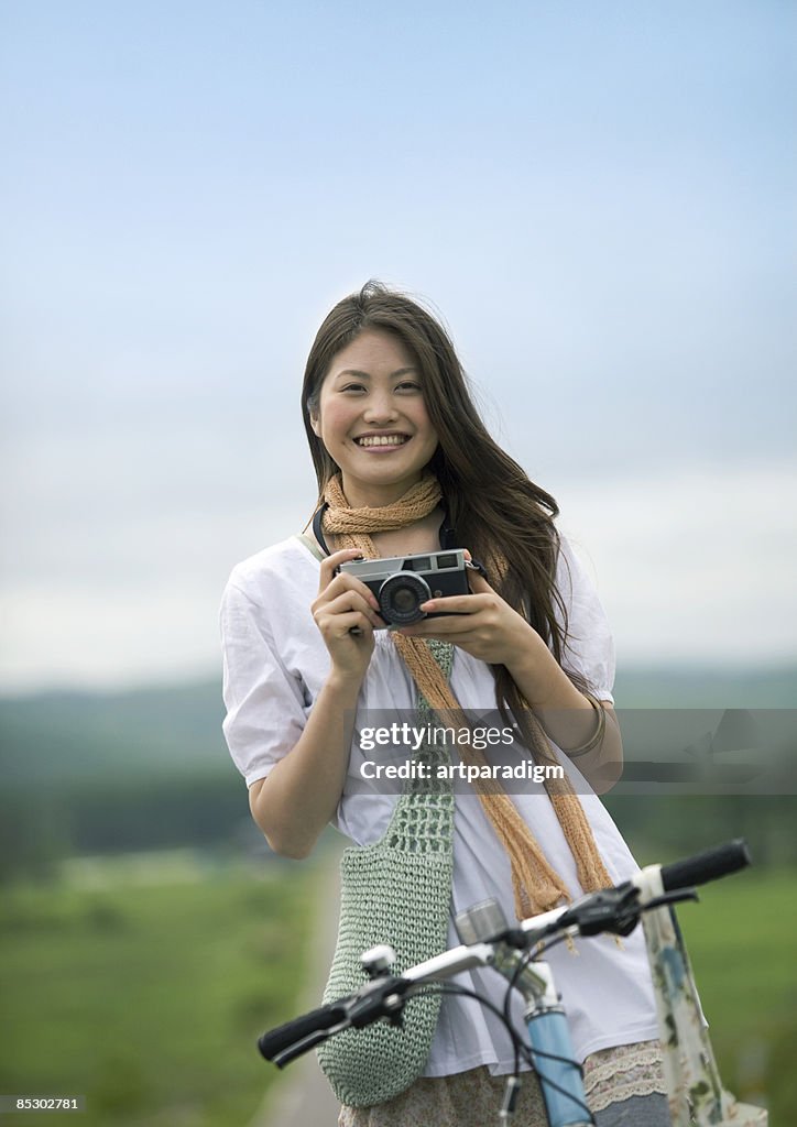 Young woman taking a photo on the straight road