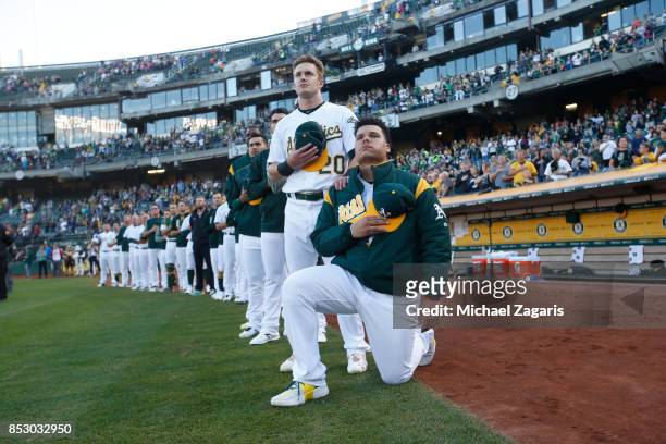 Bruce Maxwell of the Oakland Athletics kneels during the national anthem prior to the game against the Texas Rangers at the Oakland Alameda Coliseum...