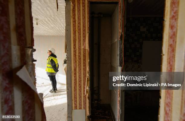 Construction worker inside an empty flat on the Heygate Estate, in Elephant and Castle, in south London, which is in the process of being demolished.