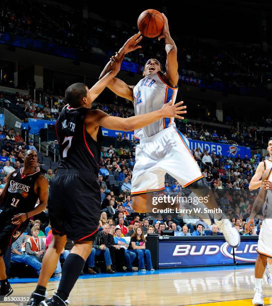 Thabo Sefolosha of the Oklahoma City Thunder goes to the basket against Andre Miller of the Philadelphia 76ers at the Ford Center on March 8, 2009 in...