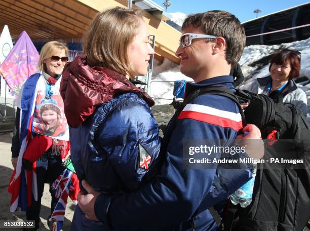 Great Britain's Lizzy Yarnold celebrates with her boyfriend James Roache, after her second run of the Women's Skeleton at the Sanki Sliding Centre,...