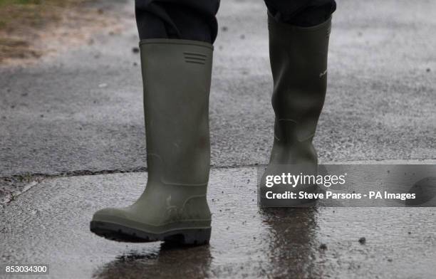 The Prime Minister and MP for Witney David Cameron's wellington boots as he talks with farmer Tim Hook near Bampton, in Oxfordshire.