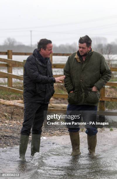 Prime Minister and MP for Witney David Cameron talks with farmer Tim Hook near Bampton, in Oxfordshire.