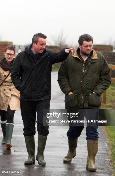 Prime Minister and MP for Witney David Cameron talks with farmer Tim Hook near Bampton, in Oxfordshire.